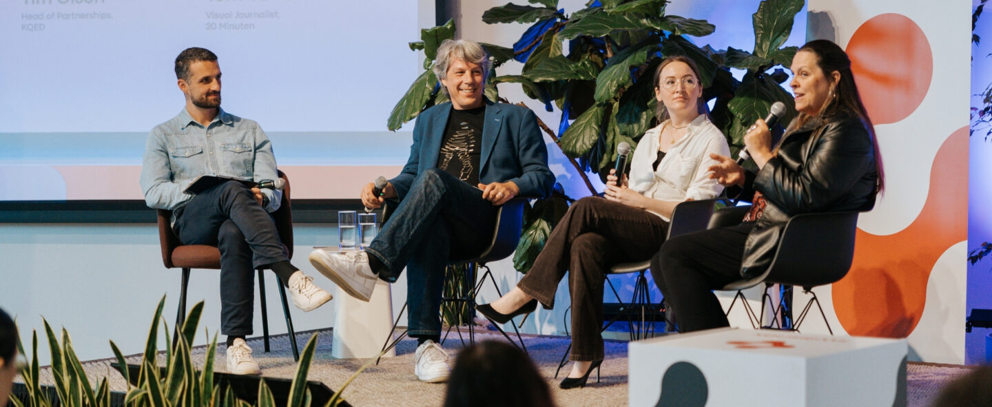 four people speaking on a stage