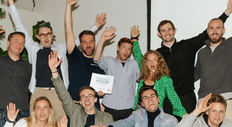 group of eleven people cheering on the winner