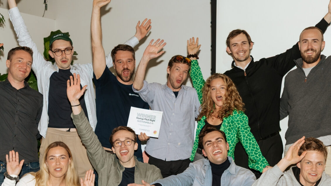 group of eleven people cheering on the winner