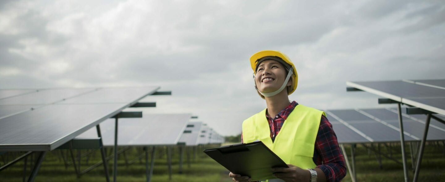 Engineer electric woman checking and maintenance of solar cells.